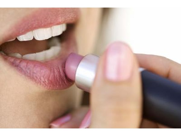 Woman applying lipstick