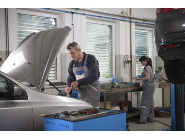 Mechanic maintaining car engine