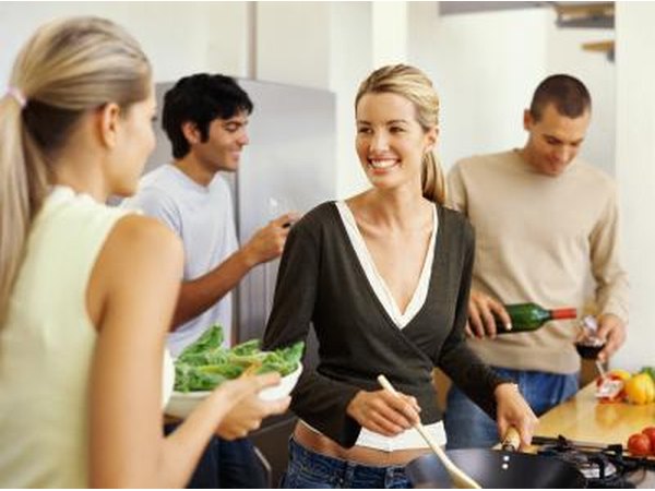 Friends cooking in kitchen