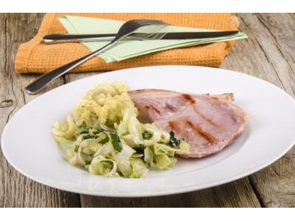 A plate of Irish bacon and cabbage on an outdoor table.
