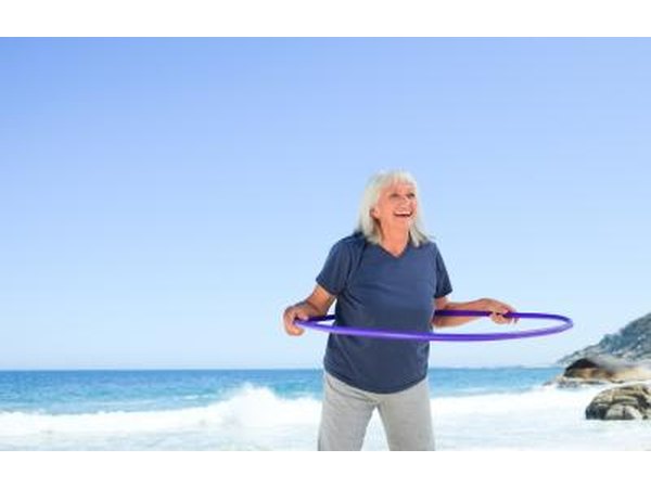 woman holding hula hoop around her body
