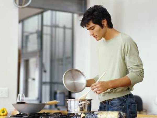 Man stirring chowder in pot
