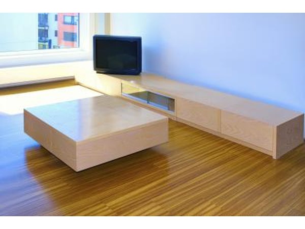 A living room has been cleared so the tables and credenzas can be used for seating and food placement