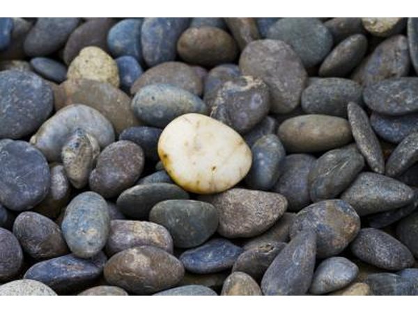 Stones sink because they displace less water than their weight.