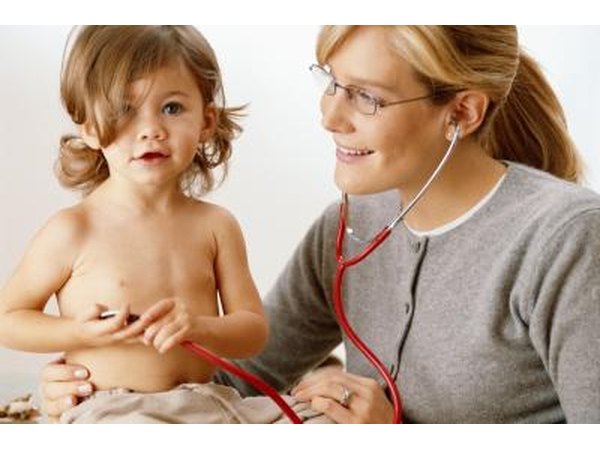 Pediatrician wearing stethoscope with toddler