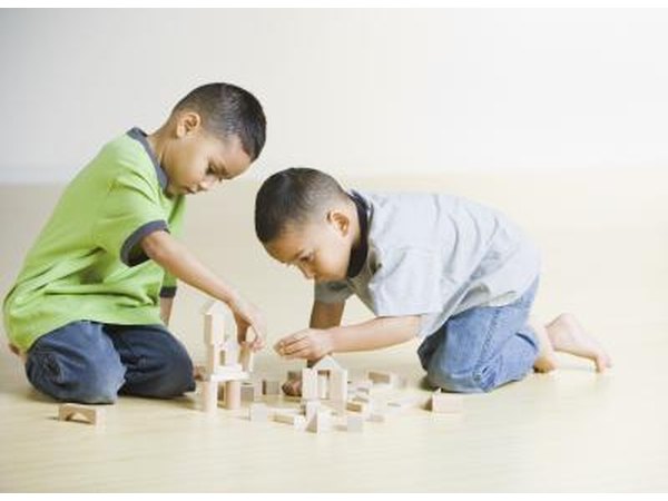 Two boys playing with building blocks