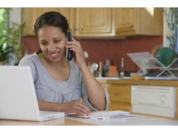 woman on phone and looking at computer