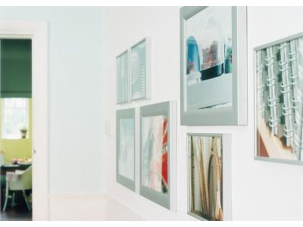 Hanging framed photos.