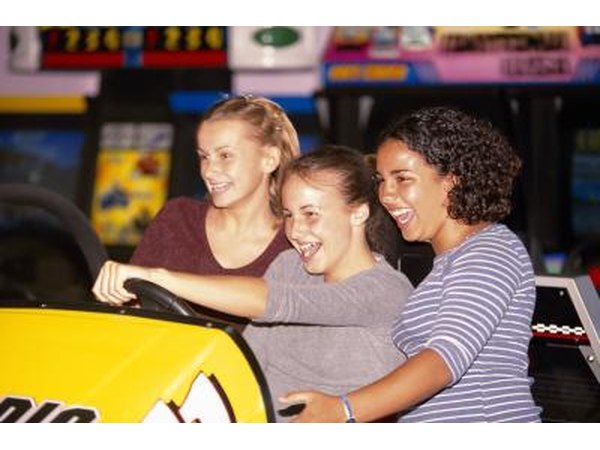 Teenage girls playing arcade game