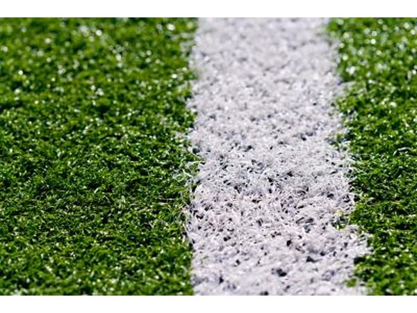 Smooth out the fill dirt so your synthetic tennis court is even.