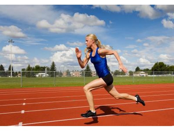 A young woman sprints on a track.