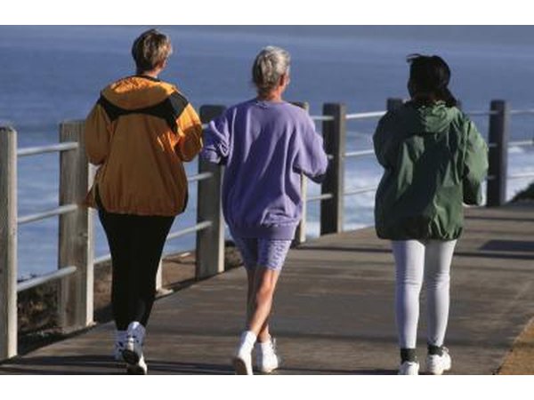 Three women take a morning jog on a pier.