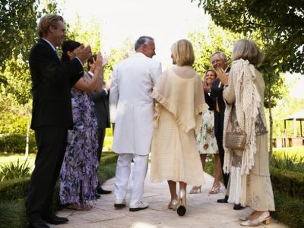 Mother of the bride escorted down the aisle
