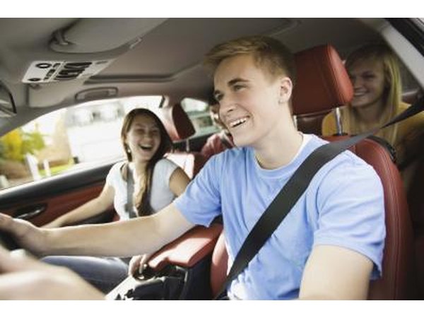 Teenage boy driving car