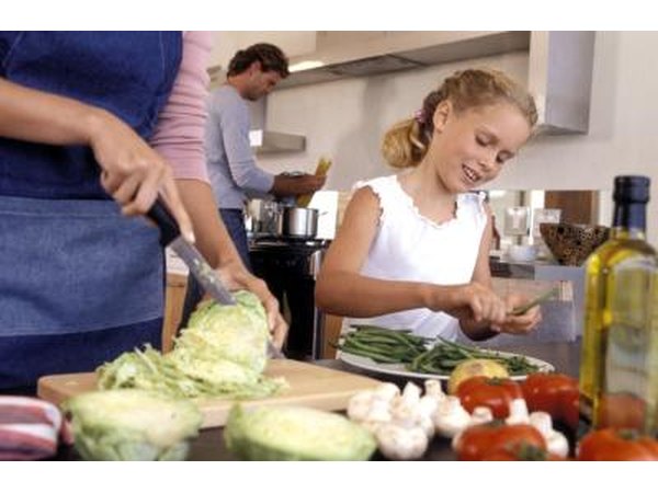 Daughter helping mother in kitchen