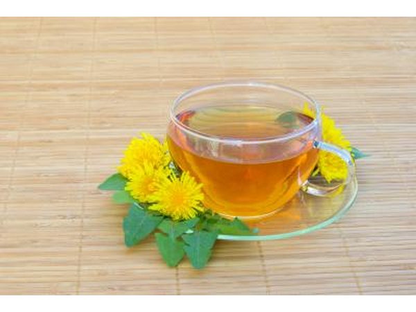 A cup or Dandelion tea surrounded by flowers