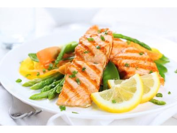 A plate of grilled salmon with vegetables.