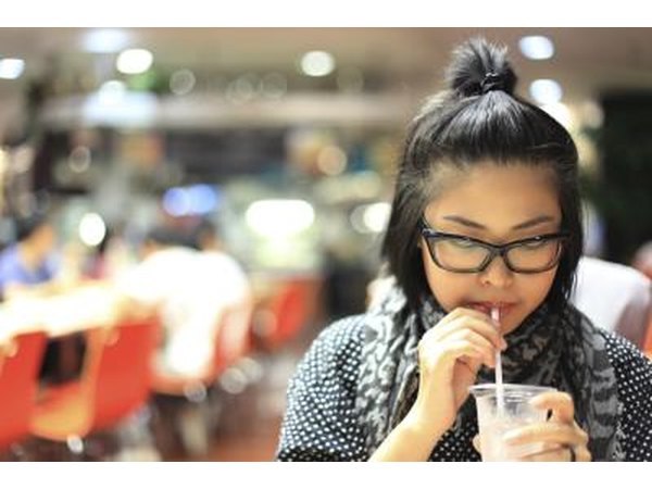 Woman drinking water in food court