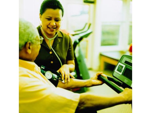 Nurse taking blood pressure of patient