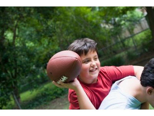 Teenage boy throwing football