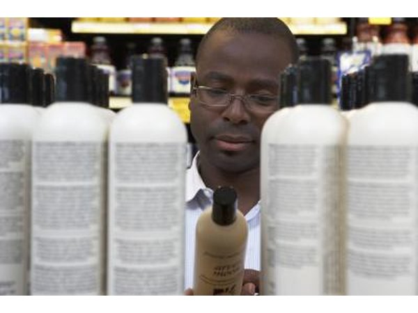 Man reading shampoo label