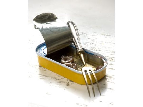 Fork leaning on a can of anchovies