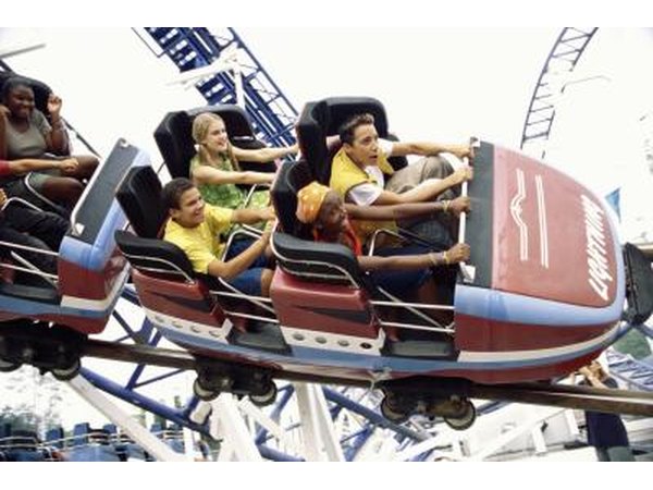 Teenage boys and girls on roller coaster ride