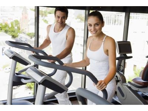 man and woman on elliptical machines