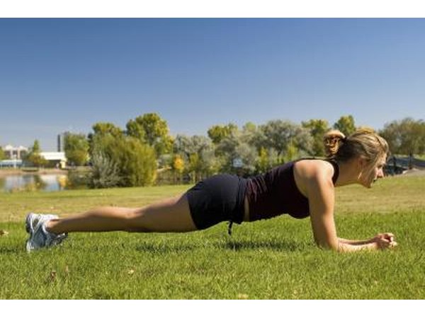 Woman holding the plank position outside.