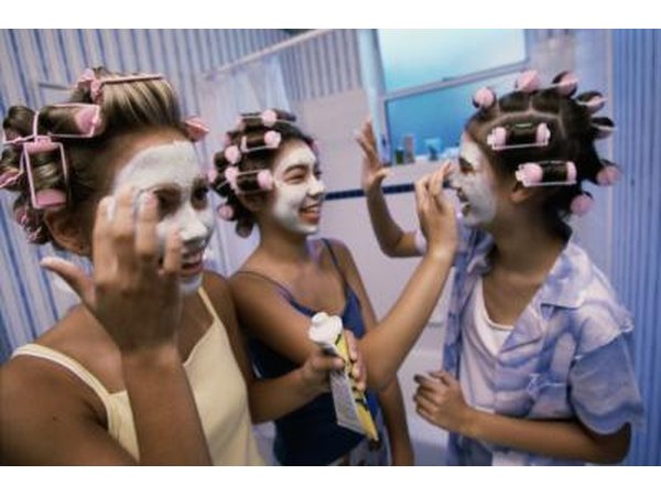 Teenage girls applying facial masks