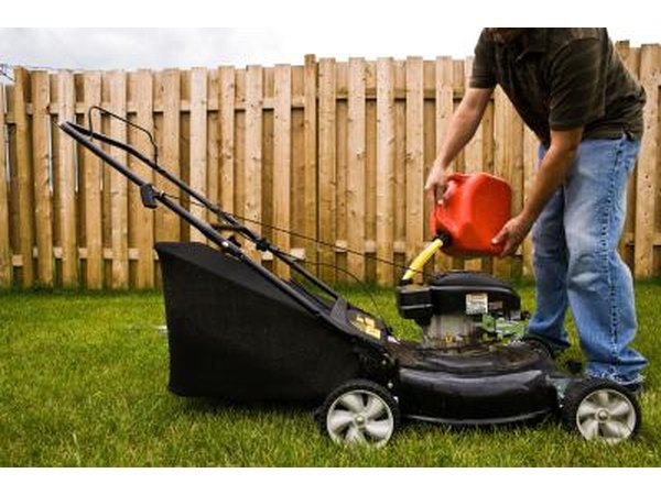 Man filling gas tank of a lawn mower
