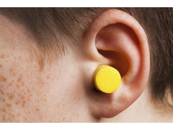 Wearing earplugs.