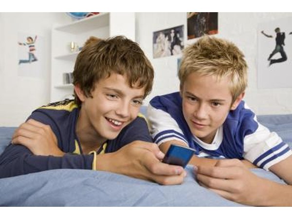Teenage boys looking at iPod Nano
