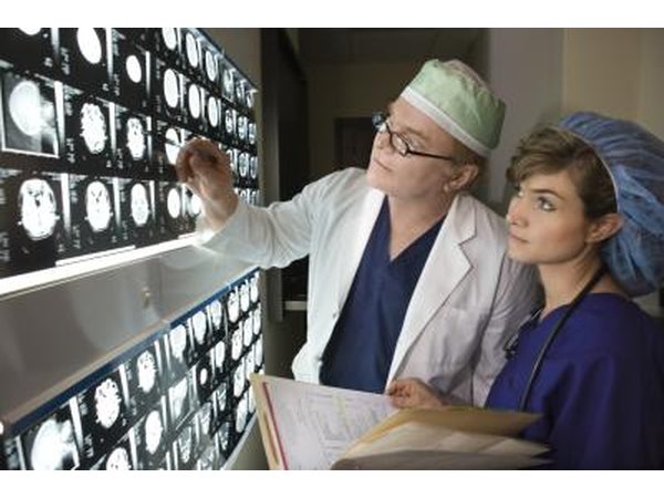 Doctor and nurse reviewing brain scans