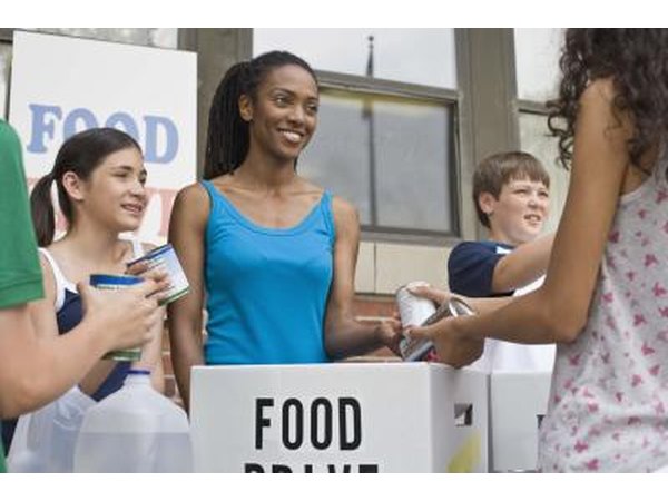 Women collecting canned foods for food drive