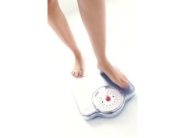Woman measuring her weight