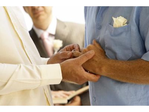 A couple exchanges rings during a wedding ceremony.