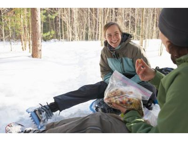 Two snowshoeing women take a break