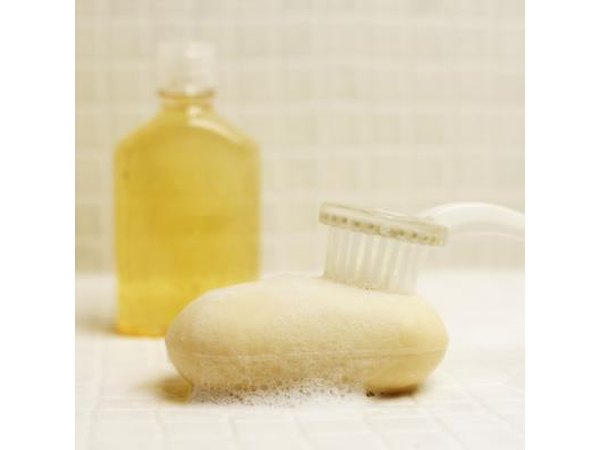 A close-up of a bar of soap and a bottle of shampoo.