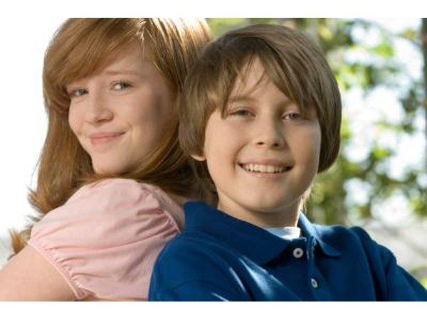 Tweens standing back to back