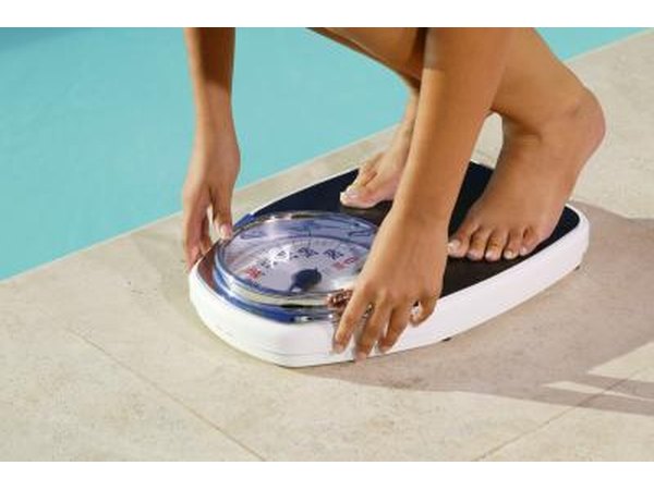 woman weighing herself on scale