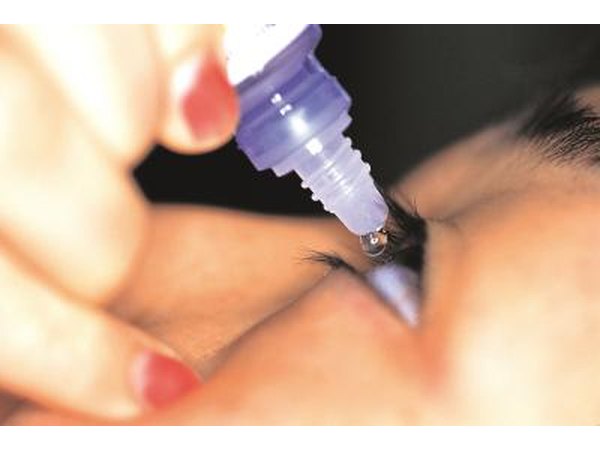 woman using Naphcon-A eyedrops