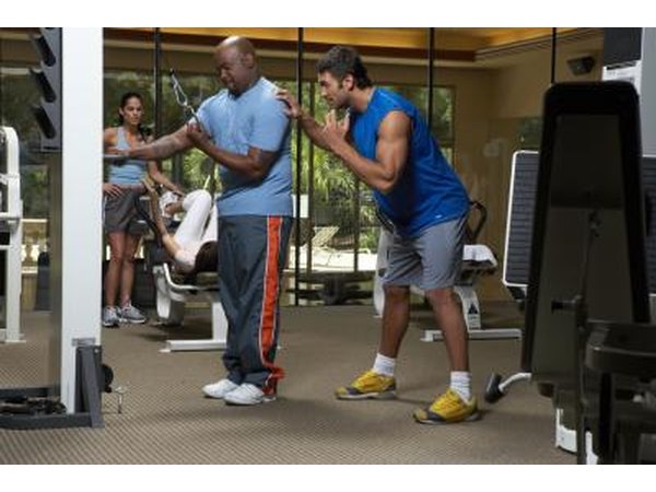 Two men are exercising in the gym.
