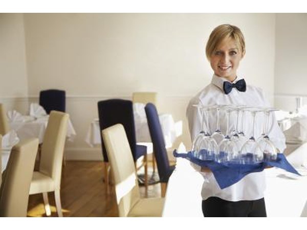 server placing glasses on table