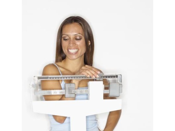 Woman smiling on scale
