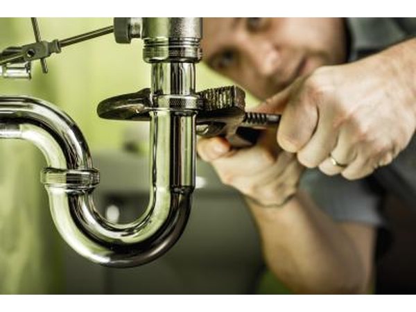 Plumber installing pipes