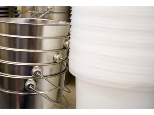Place a bucket under the water hose at the back of the washer.