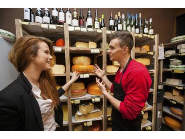 A variety of cheeses and maybe some wines can be found in a specialty cheese shop.