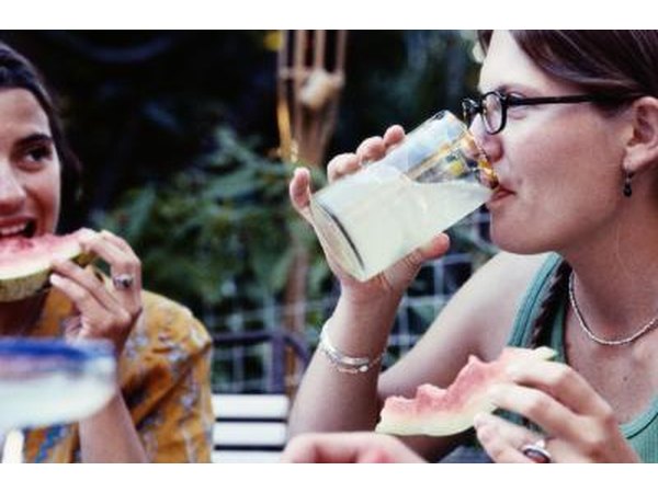 Woman drinking glass of lemonade.