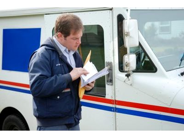 Postal worker sorts mail